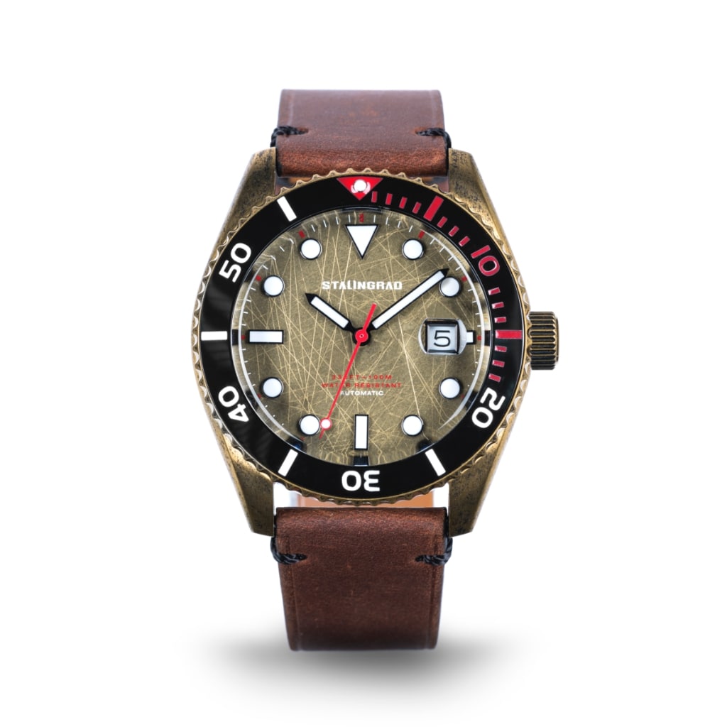 Stalingrad Volga defender automatic watch with a brass case and brass colour dial with red second hand in a brown leather strap, front view or watch on a white background