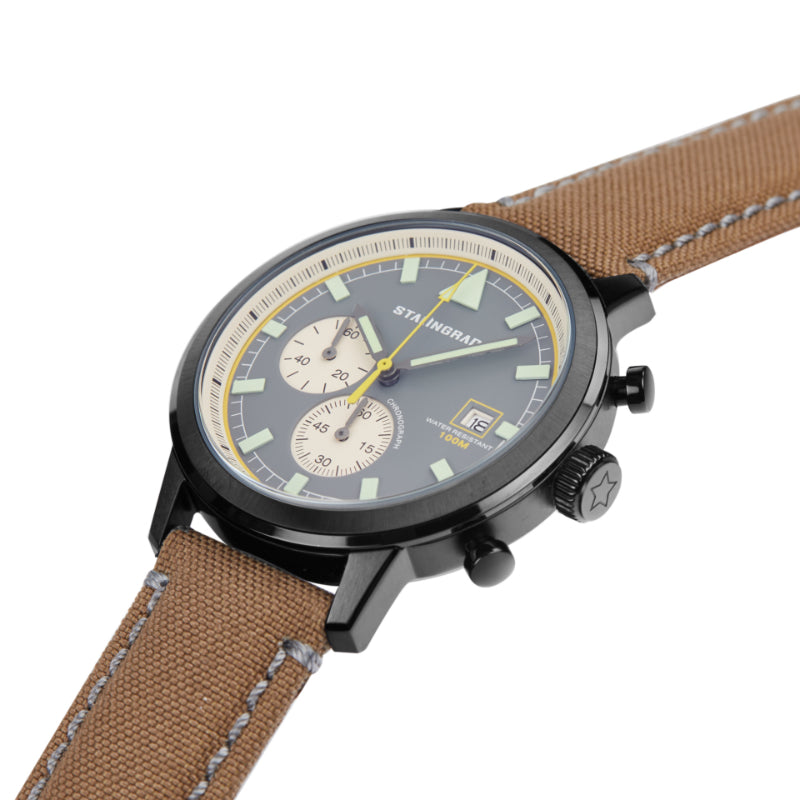 Stalingrad trooper chronograph watch with black case, grey dial and light brown Cordura straps with grey stitching, diagonal view on a white background 