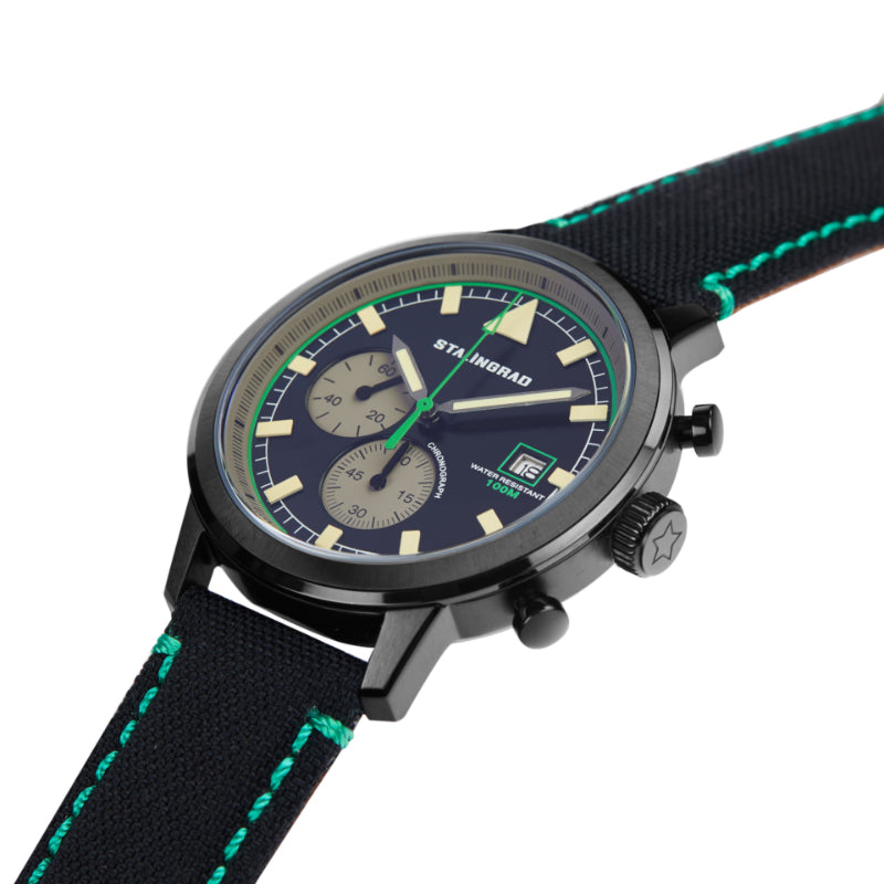 Stalingrad trooper chronograph watch with black case, black dial and black Cordura straps with green stitching, diagonal view on a white background 