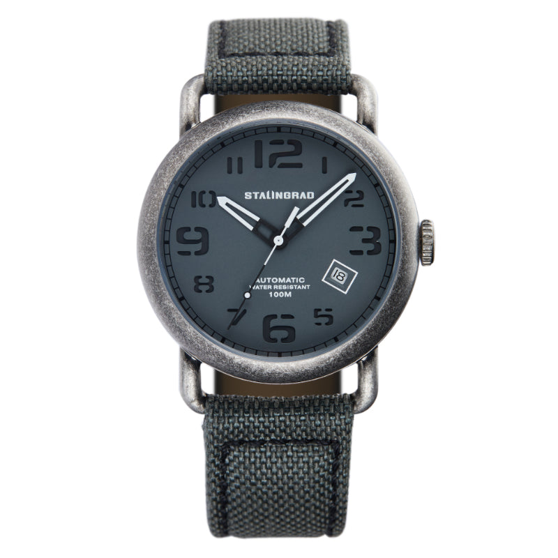 Stalingrad Rodim Watch with a sandwich dial. Grey dial with white hands, Silver case and a grey cordura strap front view of watch on white background.